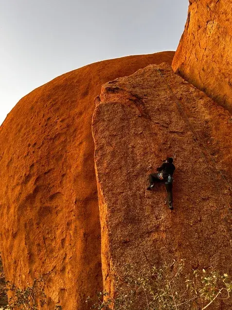 Climber on a sunlit granite face at Spitzkoppe
