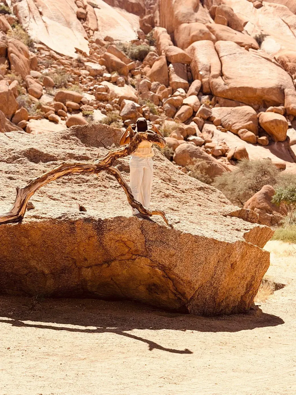 Hiker standing on a granite boulder at Spitzkoppe