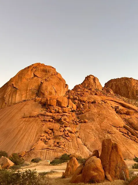 Rounded granite domes and boulders at Spitzkoppe under a pale sky